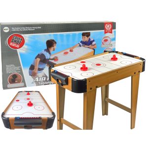 Mesa de juego de air hockey en acción con niños disfrutando