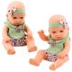 Muñeca con vestido floral verde y diadema con lazo