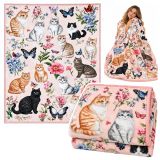 Manta decorativa con gatos y flores de Lean toys sobre un sofá